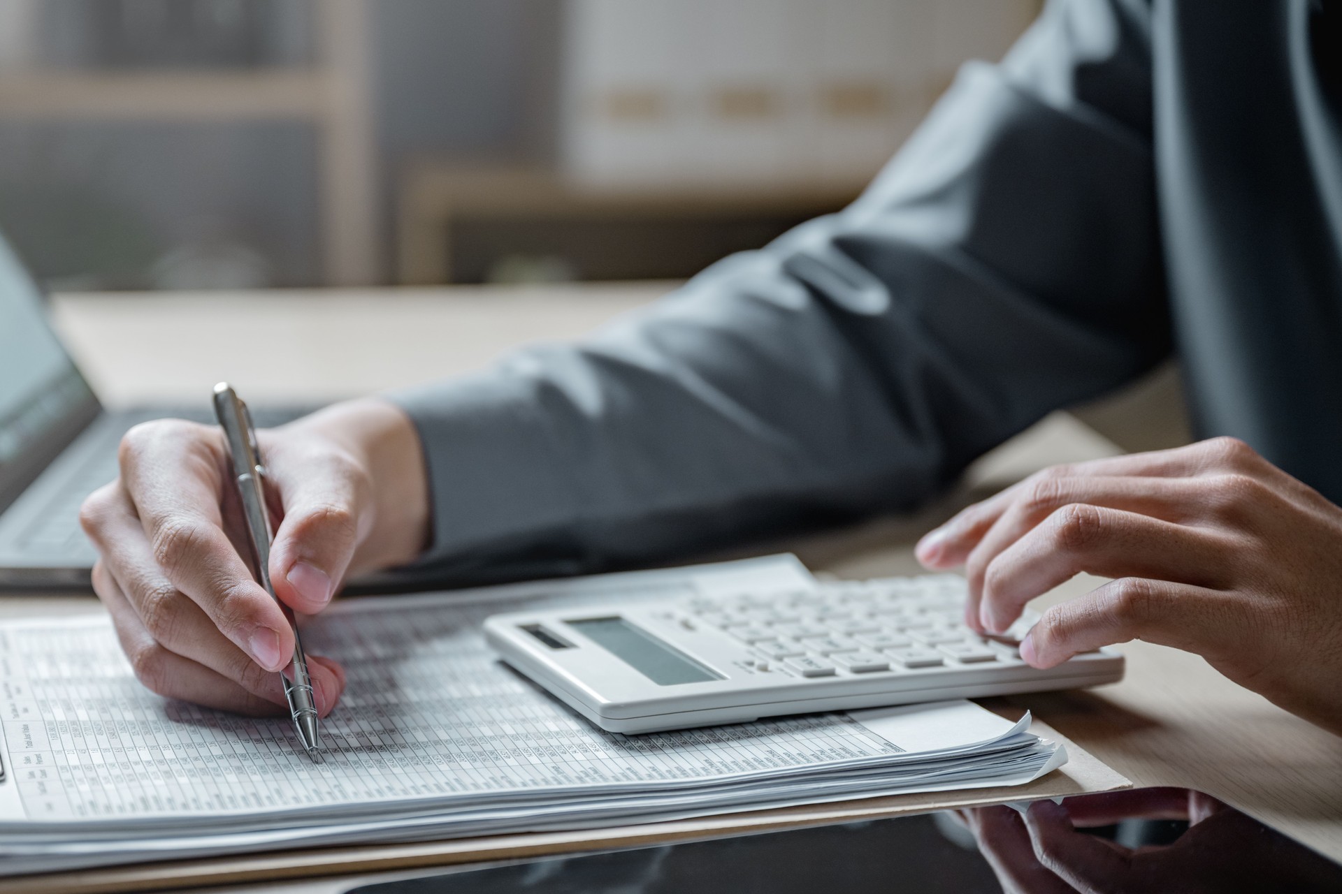 Accountant audit financial business. Accounting finance report statement. Business budget auditing. Internal cost auditing. Finance concept. A person is sitting with a laptop and a calculator.