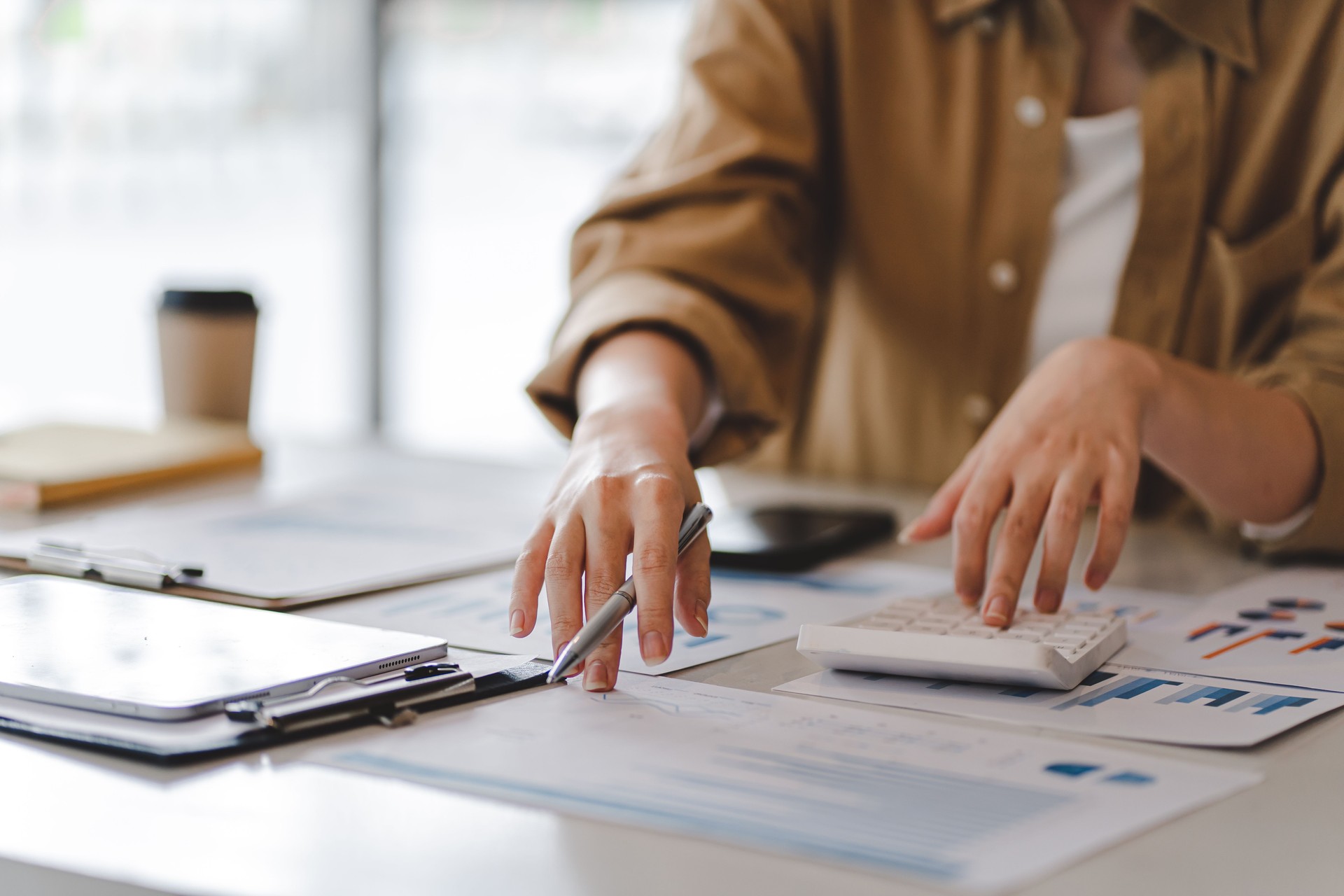 Portrait of a business woman working on a tablet computer in a modern office. Make an account analysis report. real estate investment information financial and tax system concepts